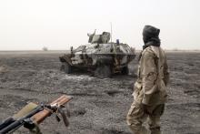 A Chadian soldier walks past an armored vehicle that the Chadian military said belonged to insurgent group Boko Haram that they destroyed in battle in Gambaru, Nigeria, February 26, 2015. PHOTO BY REUTERS/Emmanuel Braun