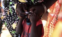 A displaced South Sudanese child receives an oral cholera vaccine in a camp for internally displaced people in the United Nations Mission in South Sudan (UNMISS) compound in Tomping, Juba, February 28, 2014. PHOTO BY REUTERS/Andreea Campeanu