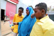 Fahmo Mantan Warsame and her children look at a photograph of Hanad Nuune Muhumed after a Reuters interview outside their home in Mogadishu, Somalia, February 21, 2018. PHOTO BY REUTERS/Feisal Omar