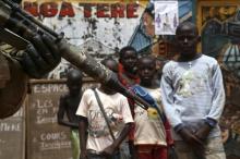 Children look at a soldier from the newly deployed EUFOR-RCA European Union military operation in the Central African Republic, patrolling along a street in Bangui, May 8, 2014. PHOTO BY REUTERS/Emmanuel Braun