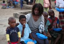 Virginia Samuel sits with two of her four children at a camp for people displaced in the aftermath of Cyclone Idai in Beira, Mozambique, March 26, 2019. PHOTO BY REUTERS/Mike Hutchings