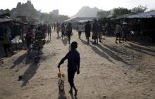 A Karamojong tribe boy plays with a toy decorated with election posters in town of Kaabong in Karamoja region, Uganda, February 17, 2016. PHOTO BY REUTERS/Goran Tomasevic