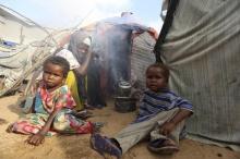 Faduma Hassan sits with her children outside her temporary dwelling after fleeing famine in Marka Lower Shebbele regions to the capital Mogadishu, September 20, 2014. PHOTO BY REUTERS/Feisal Omar