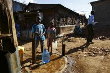 Children collect water from a communal tap in the Kibera slum of Kenya's capital Nairobi, February 26, 2015. PHOTO BY REUTERS/Darrin Zammit Lupi
