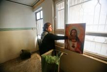 A Christian woman inspects a home in the town of Bartella east of Mosul, Iraq, after it was liberated from Islamic State militants, November 23, 2016. PHOTO BY REUTERS/Khalid al Mousily