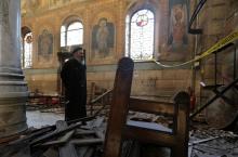 A Coptic priest stands at the scene following a bombing inside Cairo's Coptic cathedral in Egypt, December 11, 2016. PHOTO BY REUTERS/Mohamed Abd El Ghany