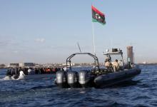 Libyan coast guards (R) escort migrants, who tried to flee to Europe, after the migrants were stopped by the coast guards and made to head to Tripoli, September 29, 2015. PHOTO BY REUTERS/Ismail Zitouny