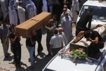 Mourners carry the coffins of victims killed by a suicide bomber attack inside a Shi'ite mosque in Baghdad, during a funeral in Najaf, south of Baghdad