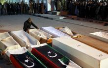 Men pray near the bodies of Libya Dawn fighters who were killed by Islamic State militants in Bin Jiwad, in Misrata March 18, 2015. PHOTO BY REUTERS/Goran Tomasevic