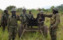 Congolese armed forces (FARDC) soldiers take position while battling M23 rebels in Kibumba, north of Goma