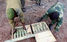 Congolese army fighters arrange their ammunitions as they take position to guard against the M23 rebels