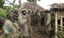 Congolese soldiers gather for a military brief after M23 rebel fighters surrendered in Chanzo village in the Rutshuru territory