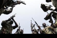 Congolese M23 rebels hold their weapons