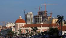 Office blocks under construction stand behind the Angolan central bank building in the capital Luanda. PHOTO BY REUTERS/Mike Hutchings