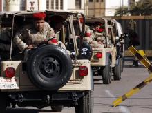 Soldiers in a convoy secure a military funeral ceremony of security personnel killed in attacks in Sinai, outside Almaza military airbase where the funerals were held, in Cairo, January 30, 2015. PHOTO BY REUTERS/Asmaa Waguih