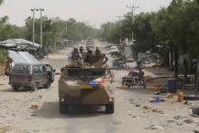 A convoy of soldiers from Niger and Chad drive down a looted street in the recently retaken town of Damasak, Nigeria, March 20, 2015. PHOTO BY REUTERS/Emmanuel Braun