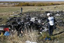 Members of the recovery team work at the site where the downed Malaysia Airlines flight MH17 crashed, near the village of Hrabove (Grabovo) in Donetsk region, eastern Ukraine, October 13, 2014. PHOTO BY REUTERS/Shamil Zhumatov