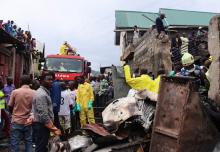 Rescuers and civilians gather at the site where a Dornier 228-200 plane operated by local company Busy Bee crashed into a densely populated neighborhood in Goma, eastern Democratic Republic of Congo, November 24, 2019. PHOTO BY REUTERS/Fiston Mahamba