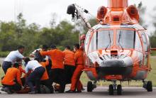 Indonesian Search and Rescue crews unload one of two bodies of AirAsia passengers recovered from the sea at the airport in Pangkalan Bun, central Kalimantan, December 31, 2014. PHOTO BY REUTERS/Darren Whiteside