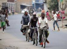 Cyclists pedal through the streets of Burundi's capital Bujumbura as the country awaits next week's presidential elections, July 18, 2015. PHOTO BY REUTERS/Mike Hutchings