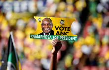 A supporter holds a placard with the face of President of South Africa's governing African National Congress Cyril Ramaphosa, during the party's final rally at Ellis Park Stadium in Johannesburg, South Africa, May 5, 2019. REUTERS/Siphiwe Sibeko