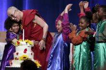 A group of children celebrate with the Dalai Lama after he blew out a candle on his birthday cake at the University of California, Irvine July 6, 2015. PHOTO BY REUTERS/Jonathan Alcorn