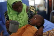 A woman feeds her daughter, who is suffering brain damage resulting from Cerebral Spinal Meningitis, at the Save the Children stabilisation ward in Maiduguri, Nigeria, November 30, 2016. PHOTO BY REUTERS/Afolabi Sotunde