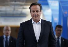 Britain's Prime Minister David Cameron returns to his hotel after giving radio interviews on the third day of the Conservative Party Conference in Birmingham, central England