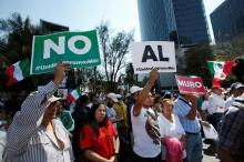 Demonstrators hold placards that collectively read "No wall" during a march to protest against U.S. President Donald Trump's proposed border wall, and to call for unity, in Mexico City, Mexico, February 12, 2017. PHOTO BY REUTERS/Ginnette Riquelme