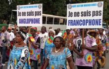 Demonstrators carry banners as they take part in a march voicing their opposition to independence or more autonomy for the Anglophone regions, in Douala, Cameroon October 1, 2017. The banners read: "I am not Francophone."(R), "I am not Anglophone" (L). PHOTO BY REUTERS/Joel Kouam