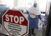 A doctor works in a laboratory on collected samples of the Ebola virus at the Centre for Disease Control in Entebbe, about 37 km (23 miles) southwest of Uganda's capital Kampala