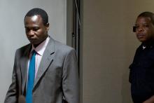 Dominic Ongwen (L), a senior commander in the Lord's Resistance Army, whose fugitive leader Kony is one of the world's most-wanted war crimes suspects, enters the court room of the International Court in The Hague, Netherlands, December 6, 2016. PHOTO BY REUTERS/Peter Dejong