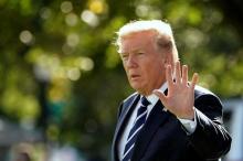 U.S. President Donald Trump waves as he walks on South Lawn of the White House before his departure to Greer, South Carolina, in Washington, U.S., October 16, 2017. PHOTO BY REUTERS/Yuri Gripas