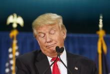 U.S. Republican presidential candidate Donald Trump stops speaking while waiting for protesters to be removed at a campaign rally at the University of Iowa in Iowa City, Iowa, January 26, 2016. PHOTO BY REUTERS/Scott Morgan