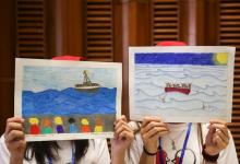 Two girls hold up their drawings about migrants during a meeting with Pope Francis at the Vatican, May 28, 2016. PHOTO BY REUTERS/Alessandro Bianchi