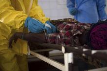 Medical staff take a blood sample from a suspected Ebola patient at the government hospital in Kenema, July 10, 2014. PHOTO BY REUTERS/Tommy Trenchard