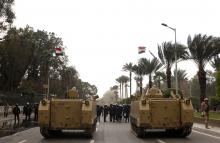 Army vehicles are parked outside Cairo university during clashes between riot policemen and Cairo University students, who are supporters of the Muslim Brotherhood and ousted Egyptian President Mohamed Mursi, in Cairo