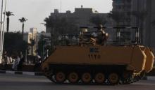 Egyptian army soldiers on an armoured personnel carrier (APC) take their position around Tahrir Square in Cairo