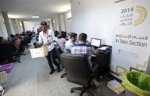 Election officials work in the operations rooms of the High National Elections Commission after elections yesterday in Tripoli