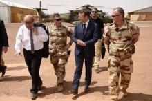 French President Emmanuel Macron (C) and French Foreign Affairs Minister Jean-Yves Le Drian (L) visit the troops of France's Barkhane operation in Africa's Sahel region in Gao, northern Mali, 19 May 2017. PHOTO BY REUTERS/Christophe Petit Tesson
