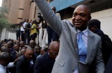 Former Congolese interior minister Emmanuel Ramazani Shadary waves to his supporters as he arrives to file his candidacy for the presidential election, at the Congo's electoral commission (CENI) head offices at the Gombe Municipality in Kinshasa, Democratic Republic of Congo, August 8, 2018. PHOTO BY REUTERS/Kenny Katombe