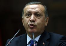 Turkey's Prime Minister Tayyip Erdogan addresses members of parliament from his ruling AK Party (AKP) during a meeting at the Turkish parliament in Ankara