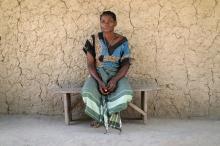 Ernestina, 50, whose son died in an attack by armed men, sits in front of a mud hut in Chitolo village, Mozambique, July 10, 2018. PHOTO BY REUTERS/Mike Hutchings