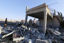 Men inspect a damaged plastics factory that was targeted on Sunday by what activists said were U.S.-led air strikes at the Islamic State's stronghold of Raqqa