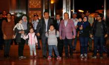 Malaysia's Foreign Minister Anifah Anan (3rd R) walks with the nine Malaysian citizens who were previously stranded in Pyongyang as they return home, at the Kuala Lumpur International Airport in Sepang, Malaysia. PHOTO BY REUTERS/Lai Seng Sin