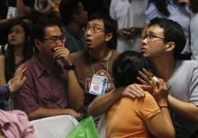 Family members of passengers onboard missing AirAsia flight QZ8501 cry at a waiting area in Juanda International Airport, Surabaya, December 30, 2014. PHOTO BY REUTERS/Beawiharta