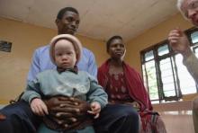 Elias Stariko (L) sits next to wife Farida Bwire, as he holds their son at the Golden Valley English Medium School, a school sponsored by Under the Same Sun (UTSS), in Geita, Tanzania in this 2011 file photo. PHOTO BY REUTERS/Emmanuel Kwitema