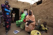 A family sit during an evening snack at their house on the outskirts of Sudan's capital Khartoum