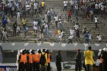 Senegalese football fans throw rocks at the police at Leopold Sedar Senghor stadium in Dakar, October 13, 2012. PHOTO BY REUTERS/Mamadou Gomis