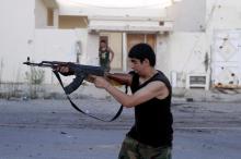 A fighter from Libyan forces allied with the U.N.-backed government aims his weapon during a battle with Islamic State fighters in Sirte, Libya. PHOTO BY REUTERS/Hani Amara